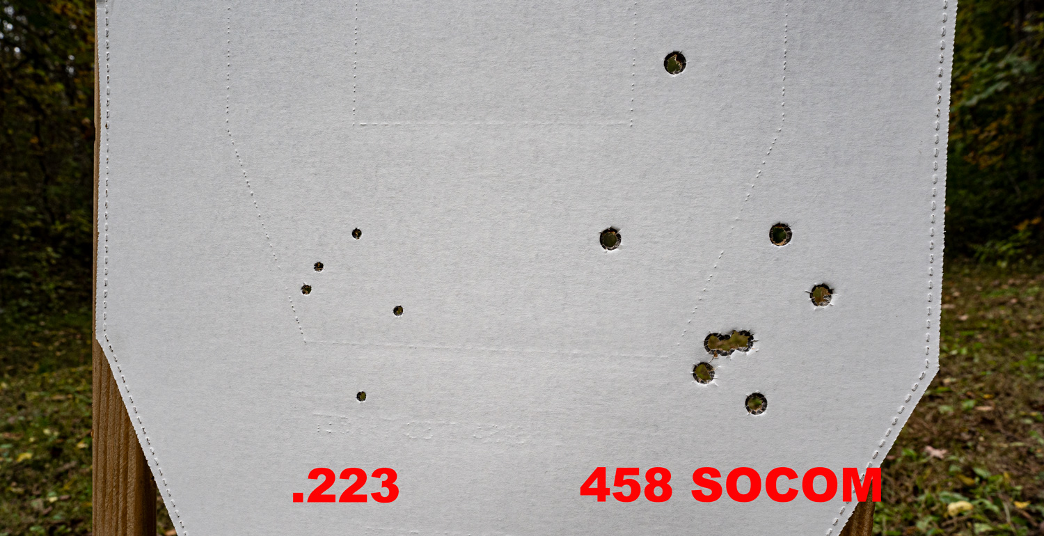 holes punched in cardboard target by 223 and by 458 SOCOM