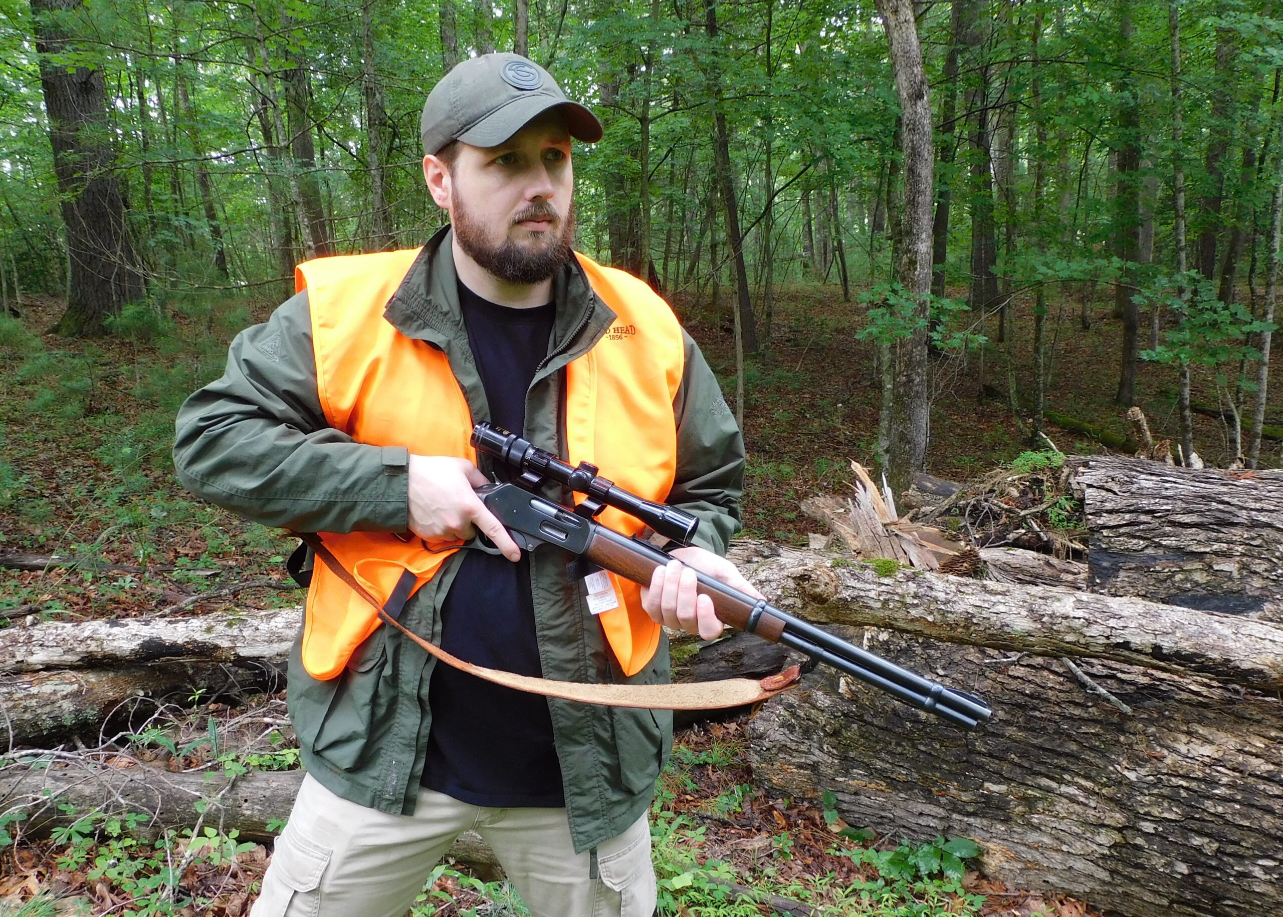 The author handling a lever action rifle with a scope