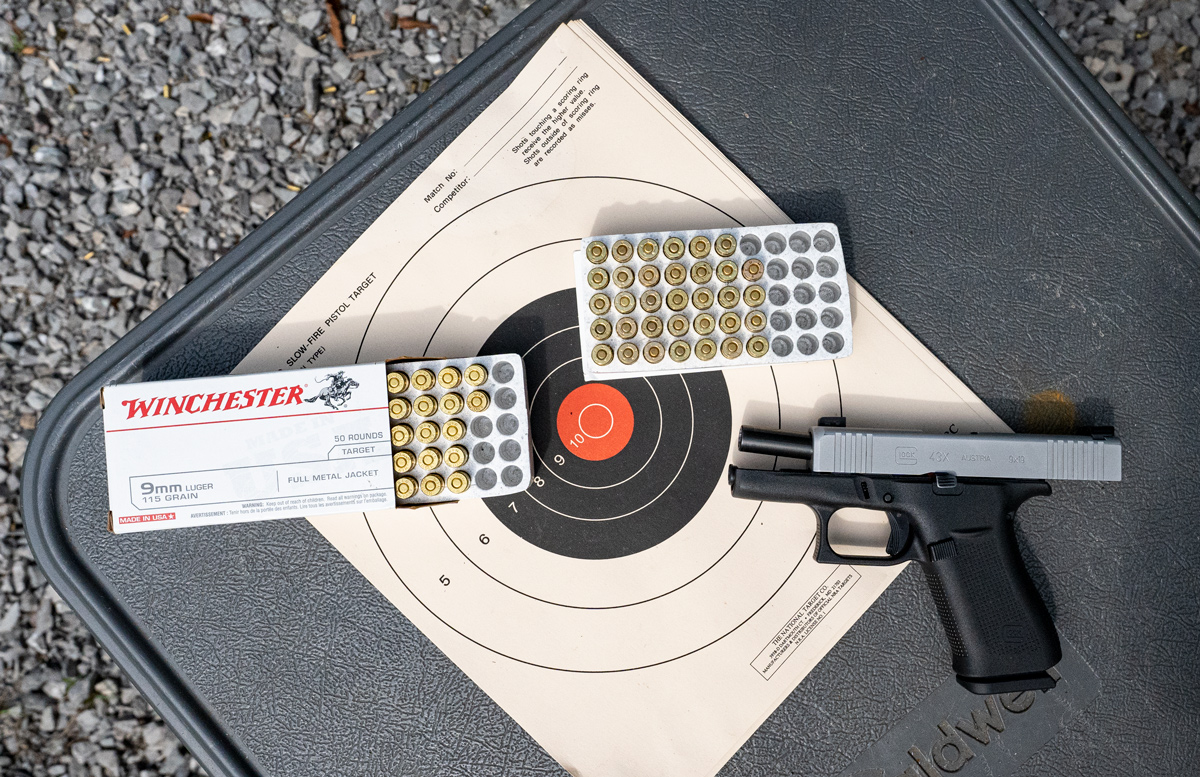 9mm pistol and ammo on shooting bench