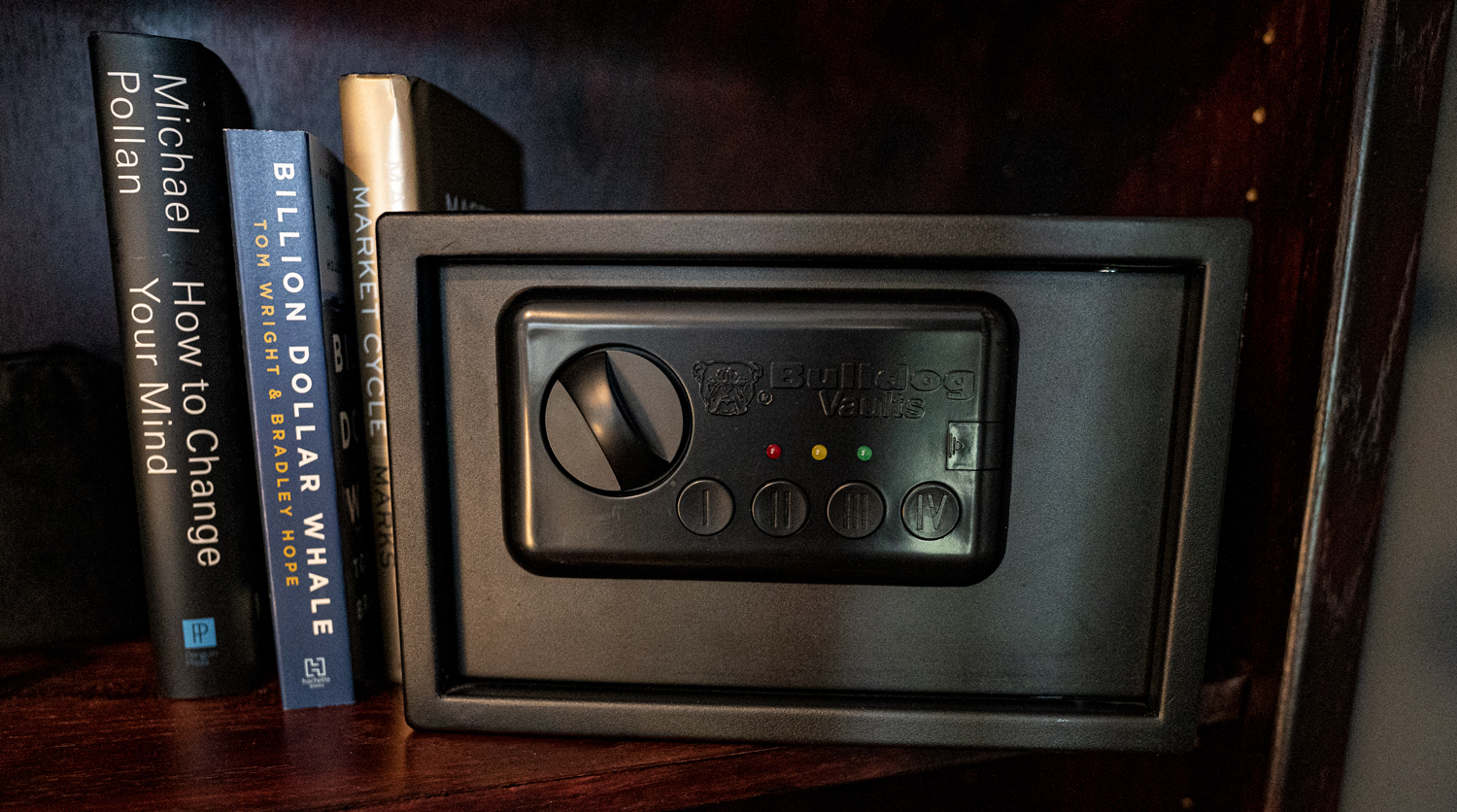 A safe for firearms on a bookcase in a home