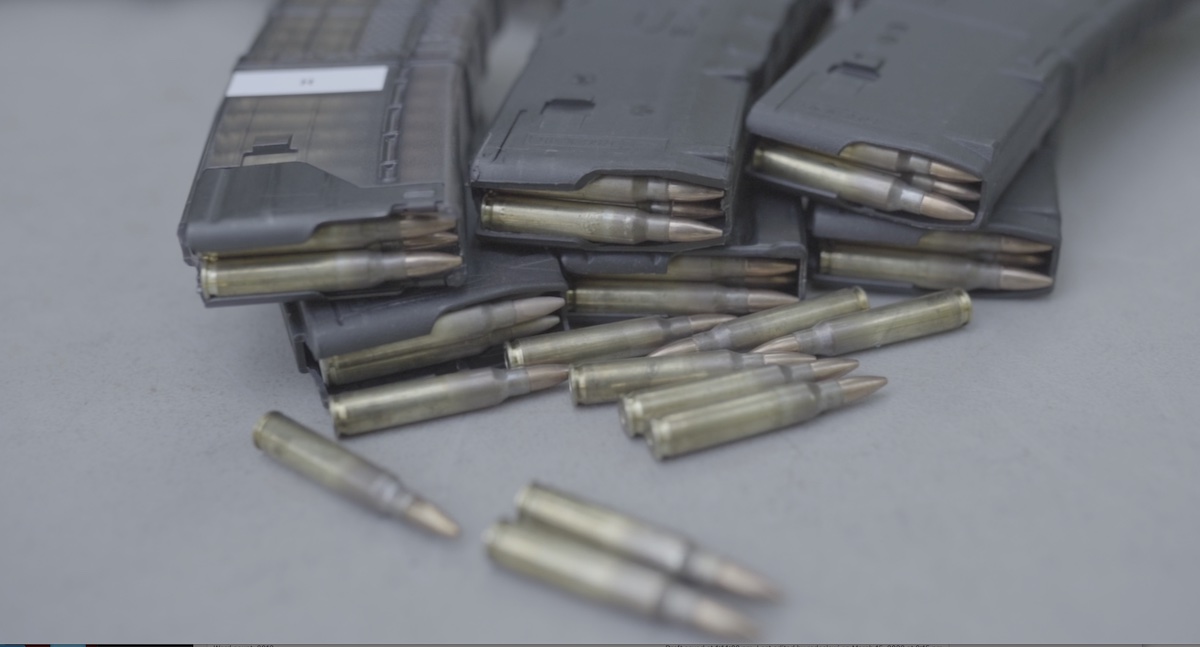 AR-15 magazines loaded with ammo on a shooting bench