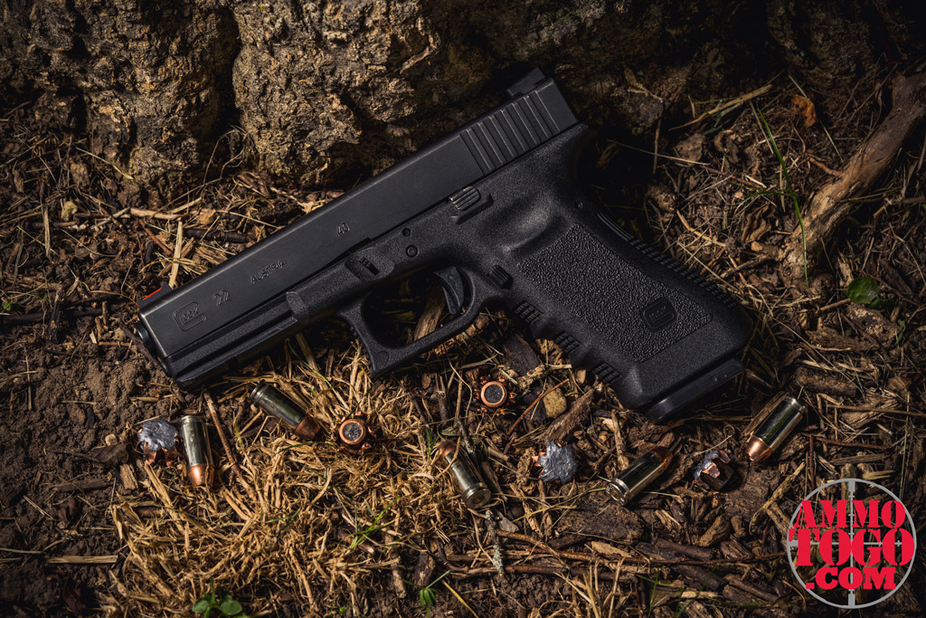 photo of a glock 22 pistol with JHP ammo outside