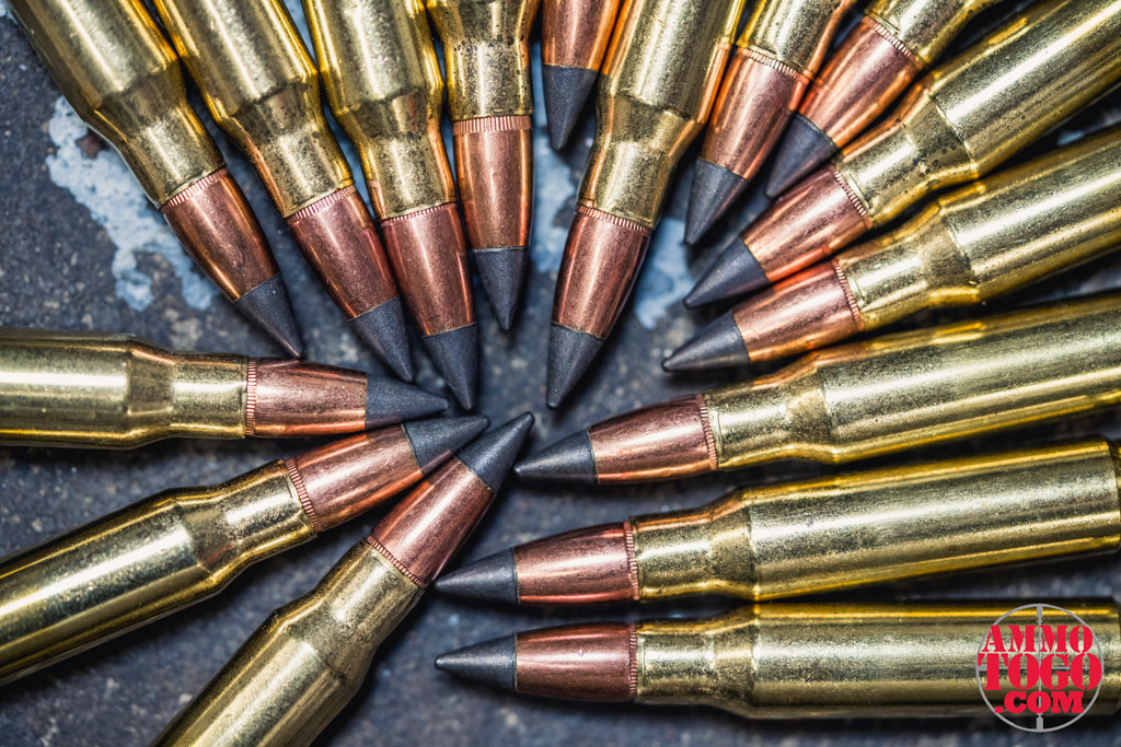 photo of hunting rifle ammunition with poly tips on a concrete floor