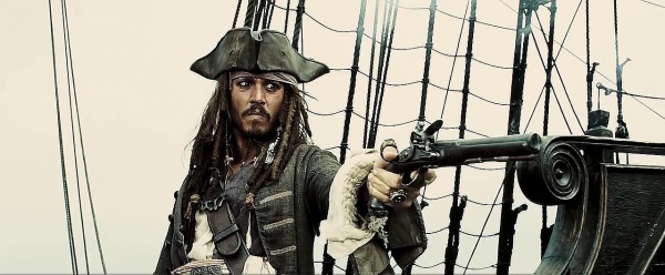 Captain Jack Sparrow points a muzzleloader pistol on a pirate ship