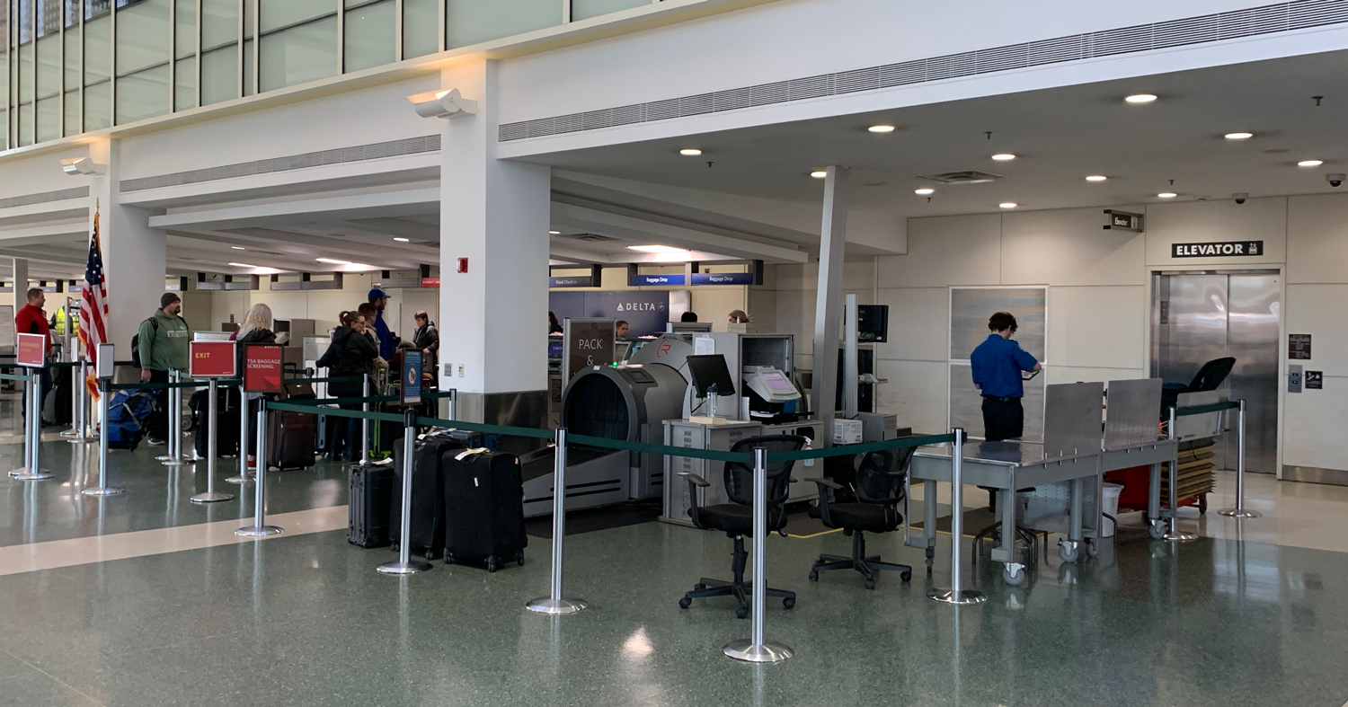 area at the airport for dropped bags, like firearm cases