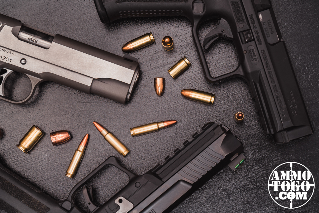 Pistols and ammunition on a black table Pistols and ammunition on a black table
