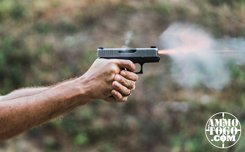 Firing a Glock 43X pistol at a shooting range