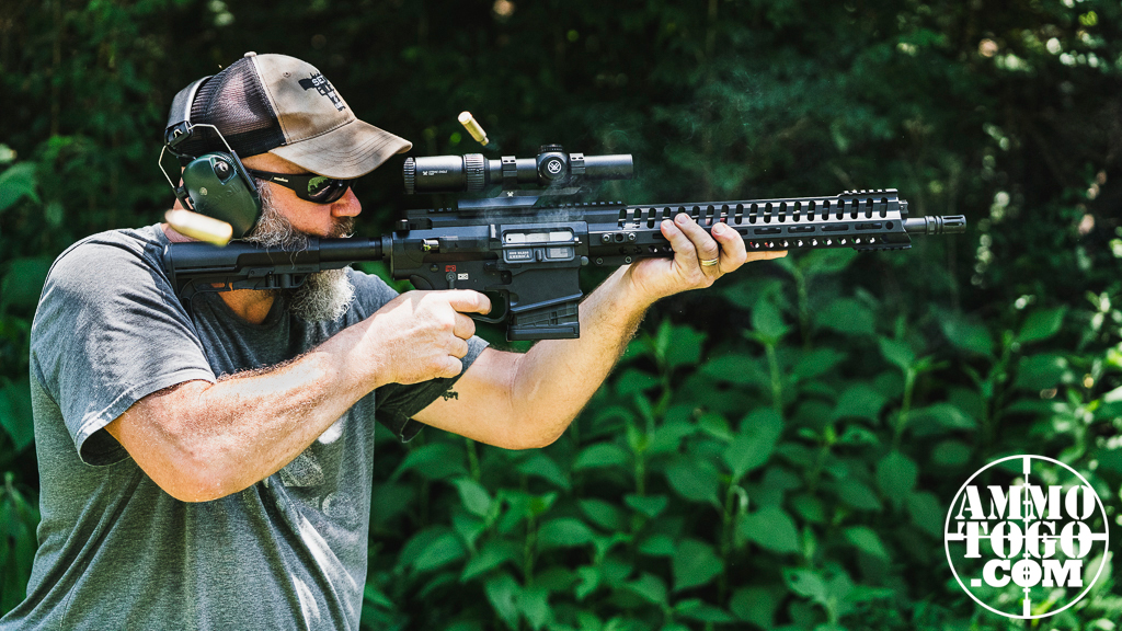 Firing the 6.5 Creedmoor from a standing position at a shooting range.
