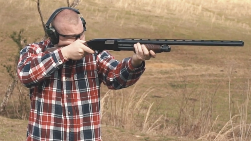 Firing a 12 gauge shotgun at the range