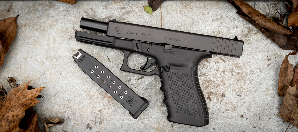 Glock 10mm pistol with magazine on a bench