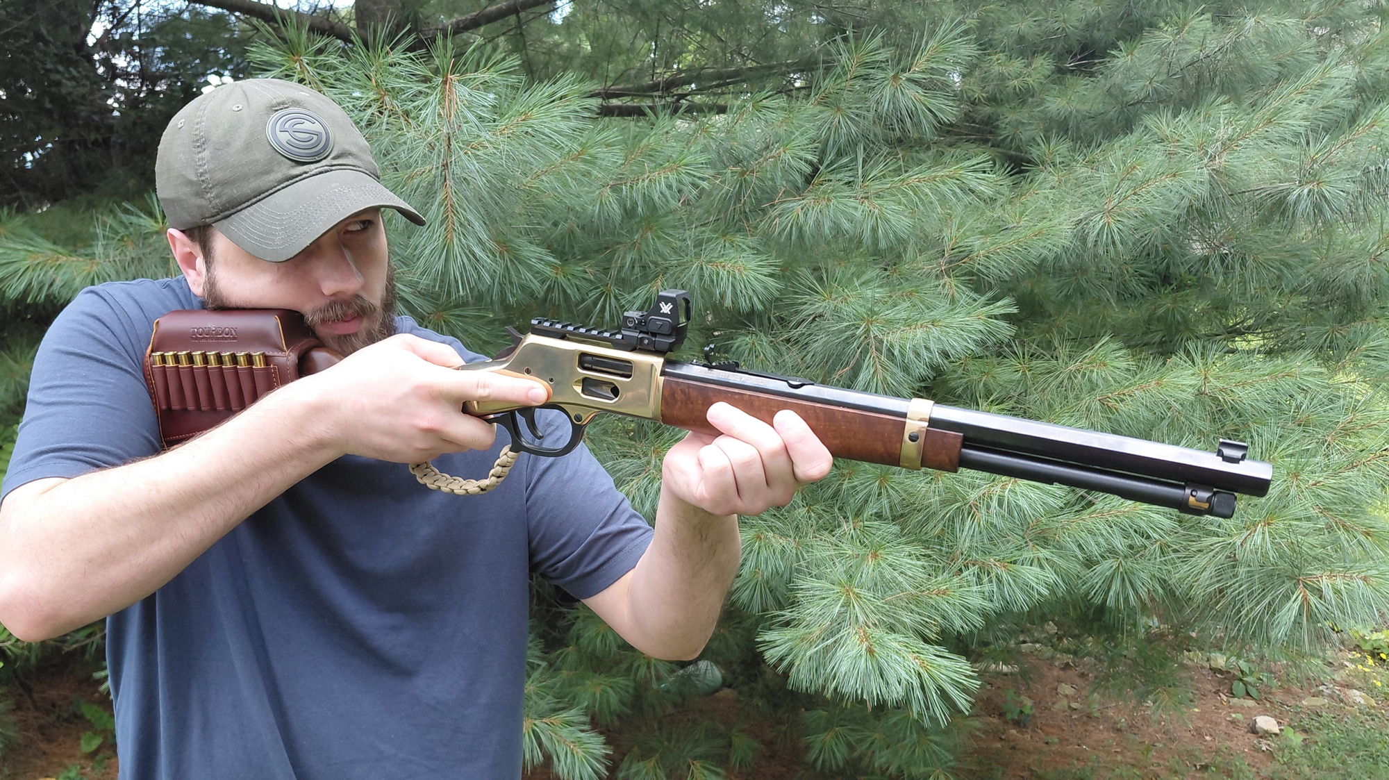 The author holding a Henry Big Boy carbine with a mounted red dot