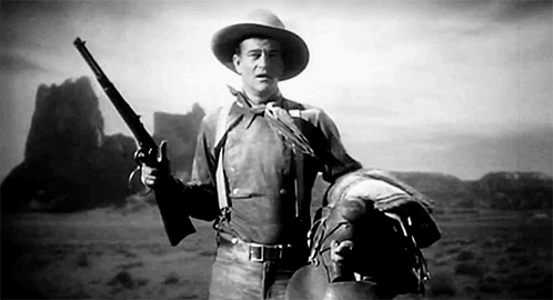 John Wayne twirling a lever action rifle