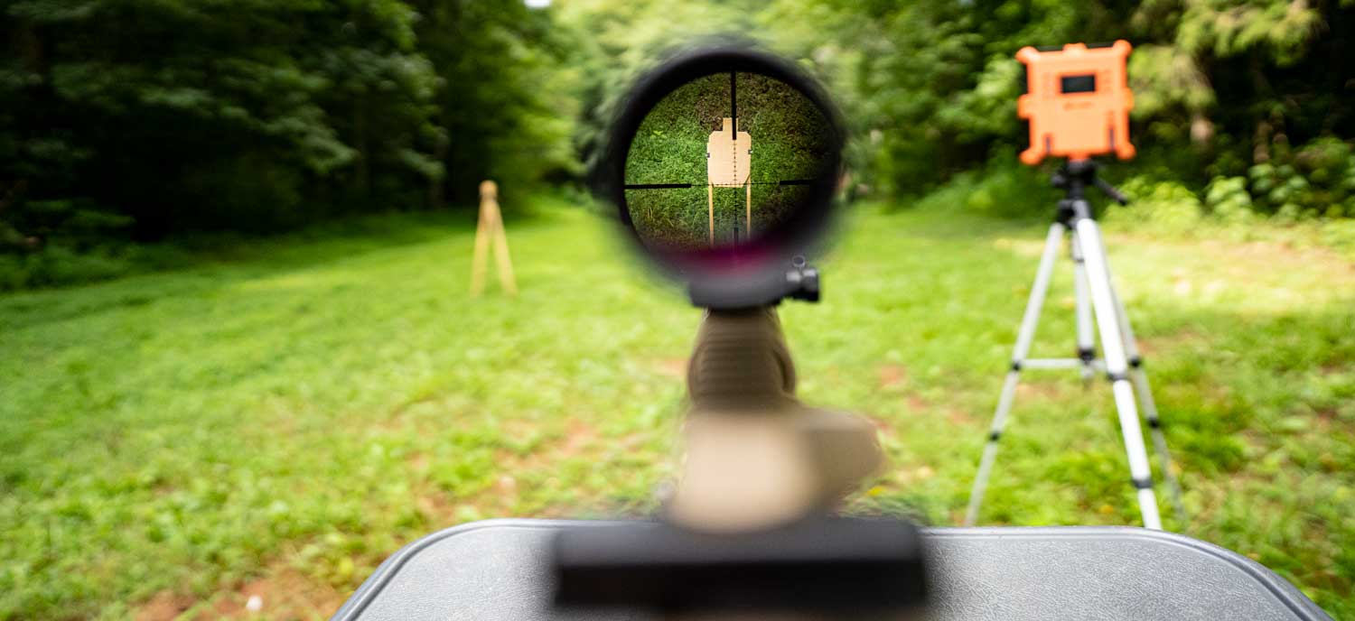 Looking through the scope of a rifle downrange