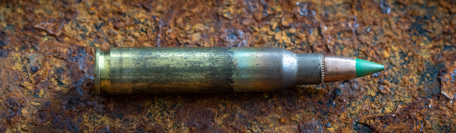 Single cartridge of M855 ammunition on a table