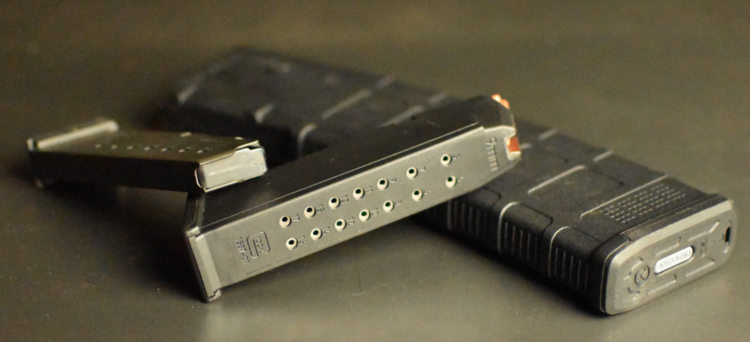 magazines for guns stacked on a table