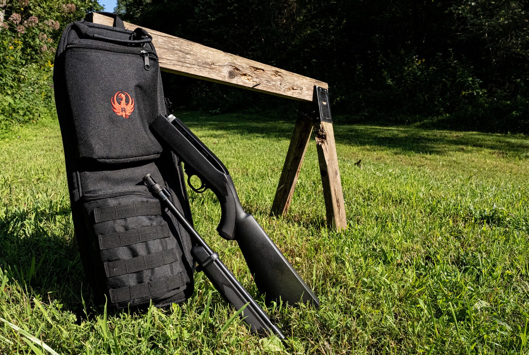 Ruger takedown 10-22 rifle leaning against a saw horse