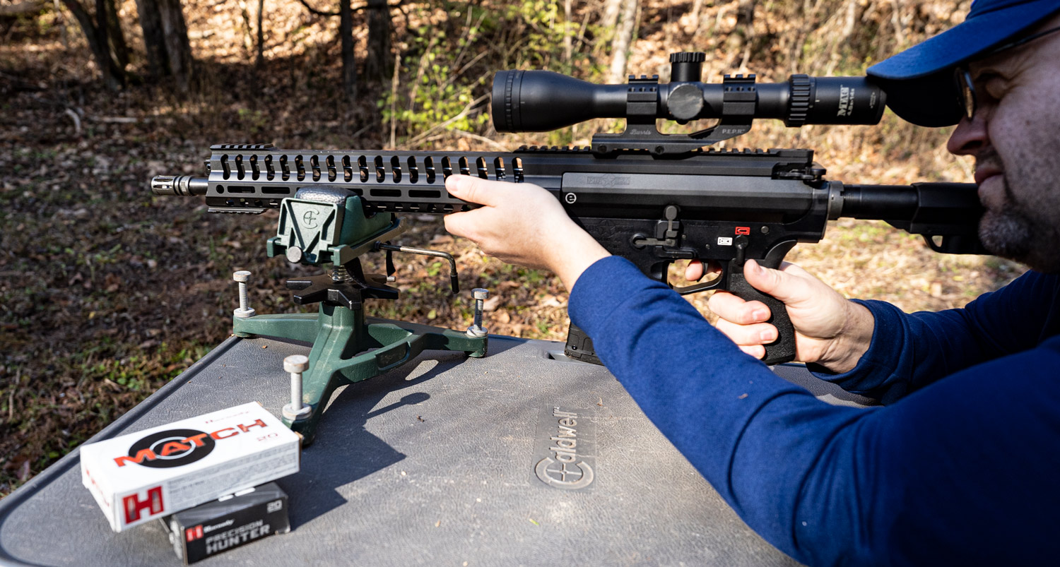 the author shooting a 6.5 creedmoor rifle with a muzzle brake at the range