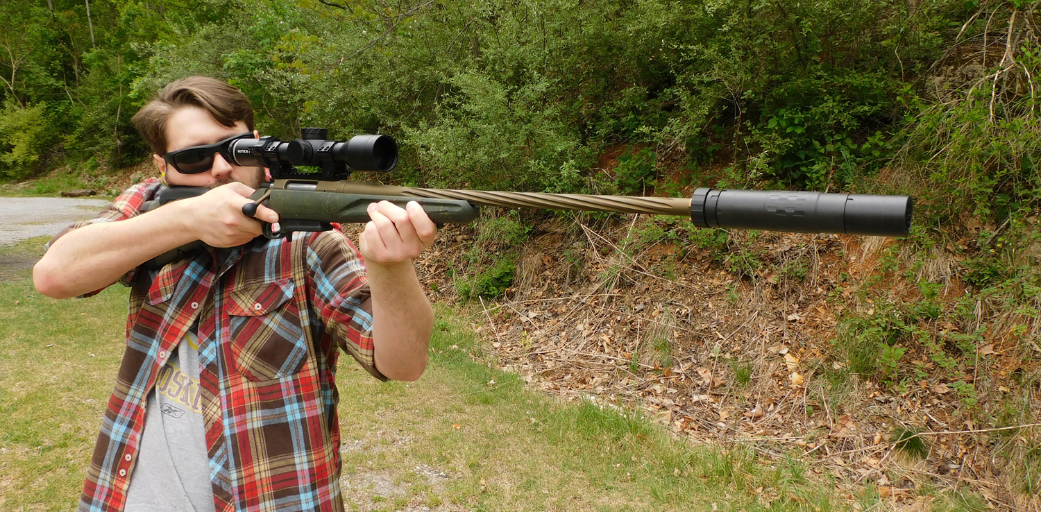Shooting-the-Ruger-American-with-a-suppressor The author shooting the Ruger American rifle with a suppressor