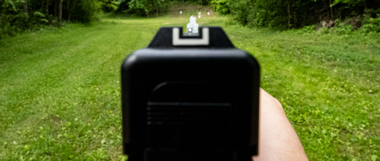 Proper sight picture looking down a pistol barrel at the range
