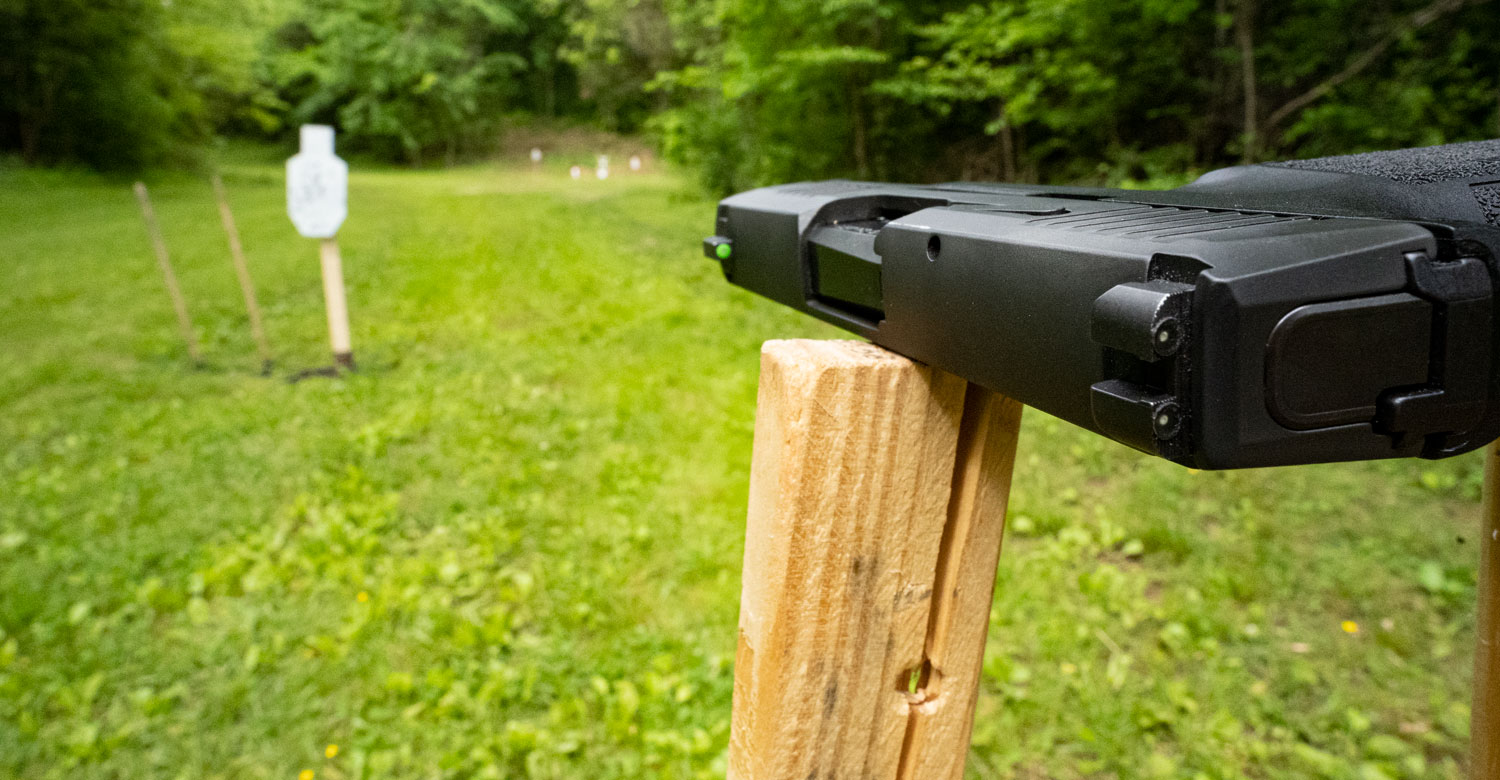 sights on a steel target at a shooting range