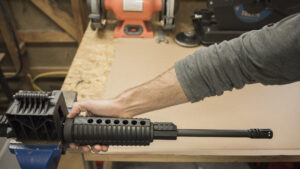 Secure the AR-15 upper receiver with barrel into a vice
