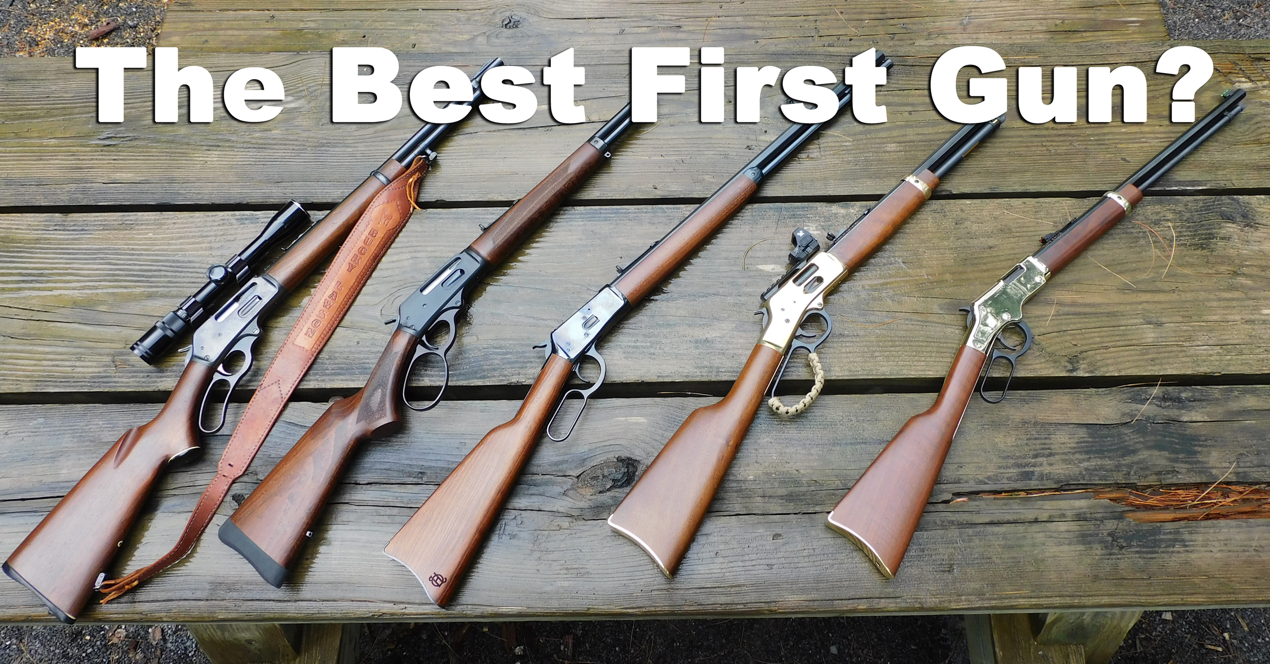A line-up of lever action rifles on a wooden background