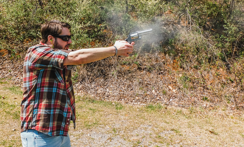 Shooter firing a Colt Anaconda with visible recoil