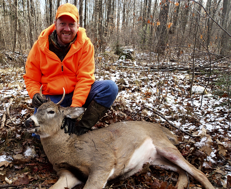 deer hunter with a buck he shot
