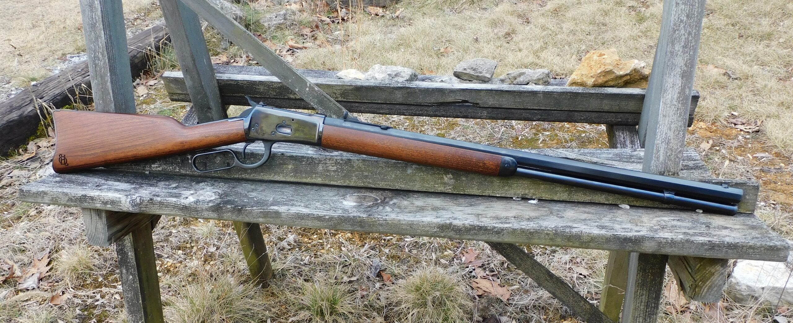 The right-side profile of Heritage 92 rifle Right-side profile of Heritage 92 lever-action rifle on wooden sawhorse showing Heritage Firearms logo