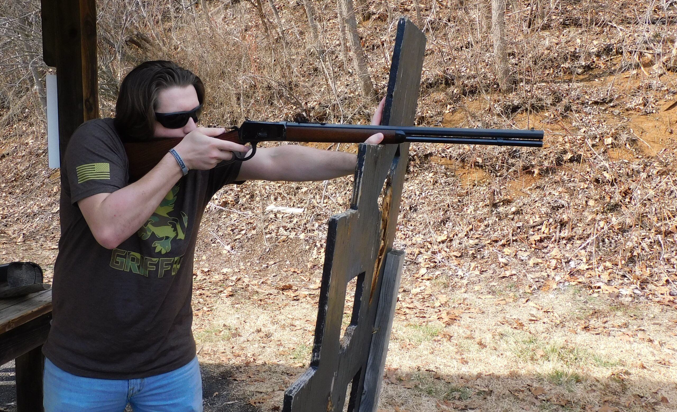 Shooting Heritage 92 with support Shooter firing Heritage 92 lever-action rifle from supported position using wooden post at range
