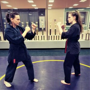 Demonstrating a martial arts stance and its similarity to the shooting stance