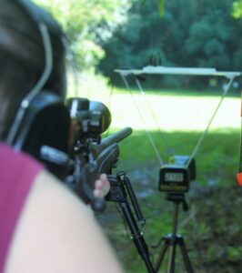 The author firing a .308 rifle through a chronography with match ammo