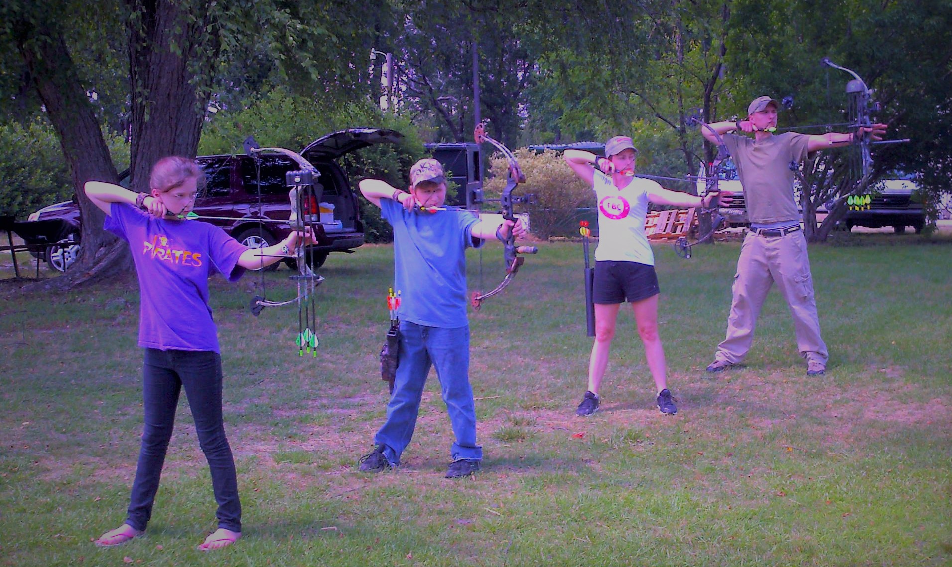 kids lined up to practice with bow and arrows for deer hunts in the future