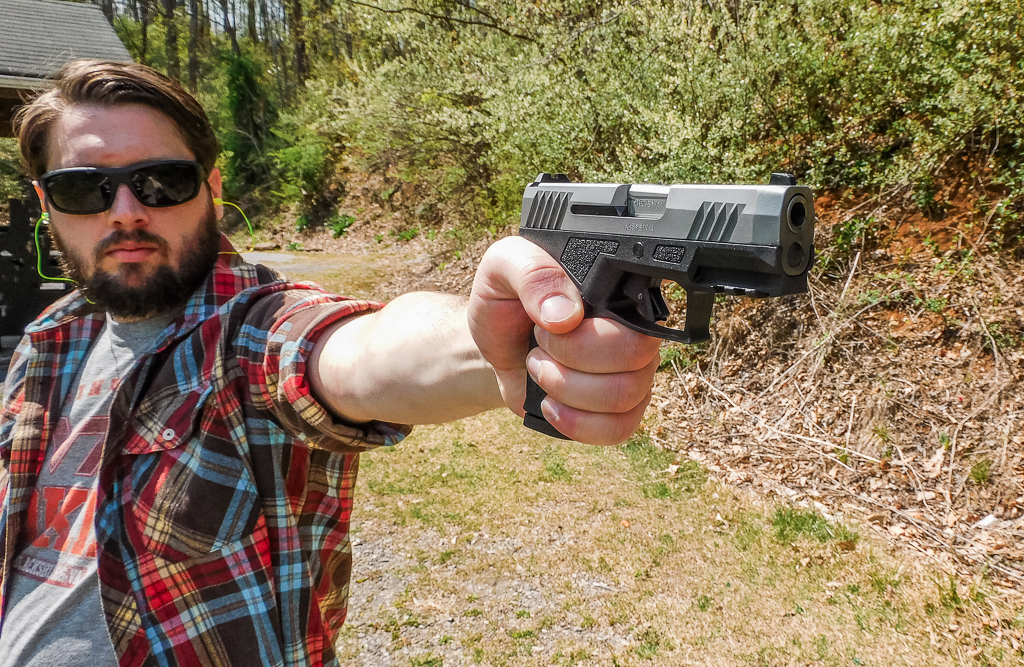 Shooter pointing the Taurus GX2 one-handed